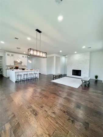 a room with lots of furniture and a kitchen view