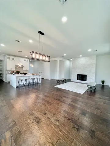 a room with lots of furniture and a kitchen view