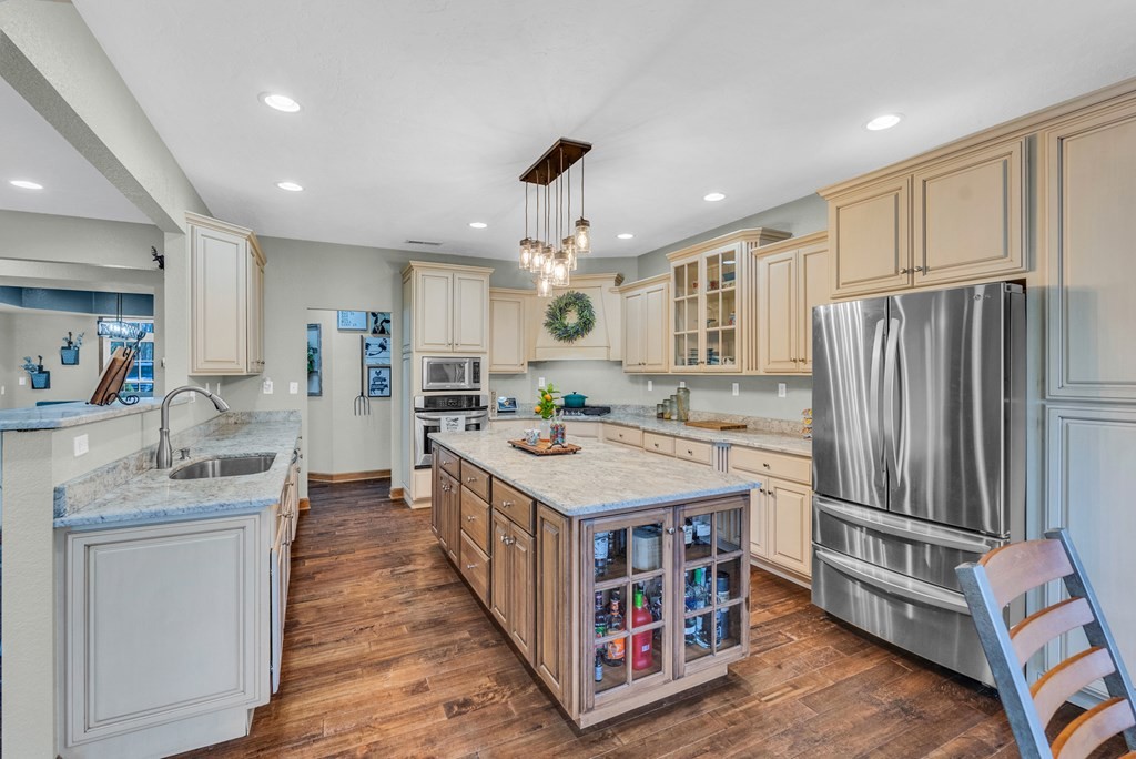 700 Falls Road Monterey, TN 38574 - Photo 16 of 72 a kitchen with kitchen island stainless steel appliances a stove refrigerator sink and cabinets
