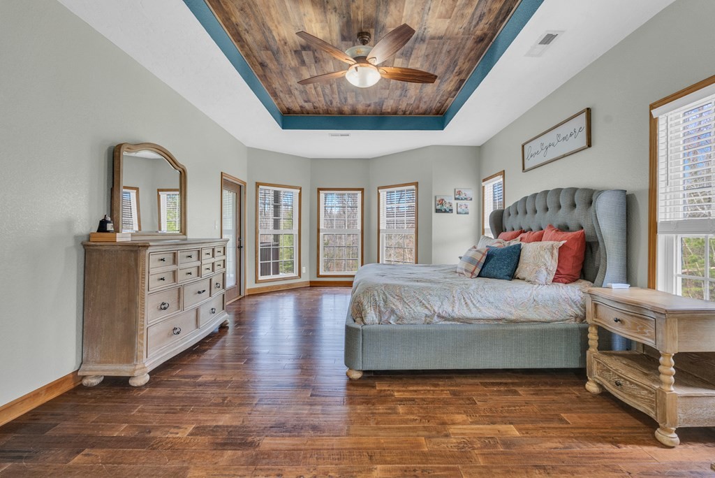 700 Falls Road Monterey, TN 38574 - Photo 18 of 72 a spacious bedroom with a bed and a chandelier