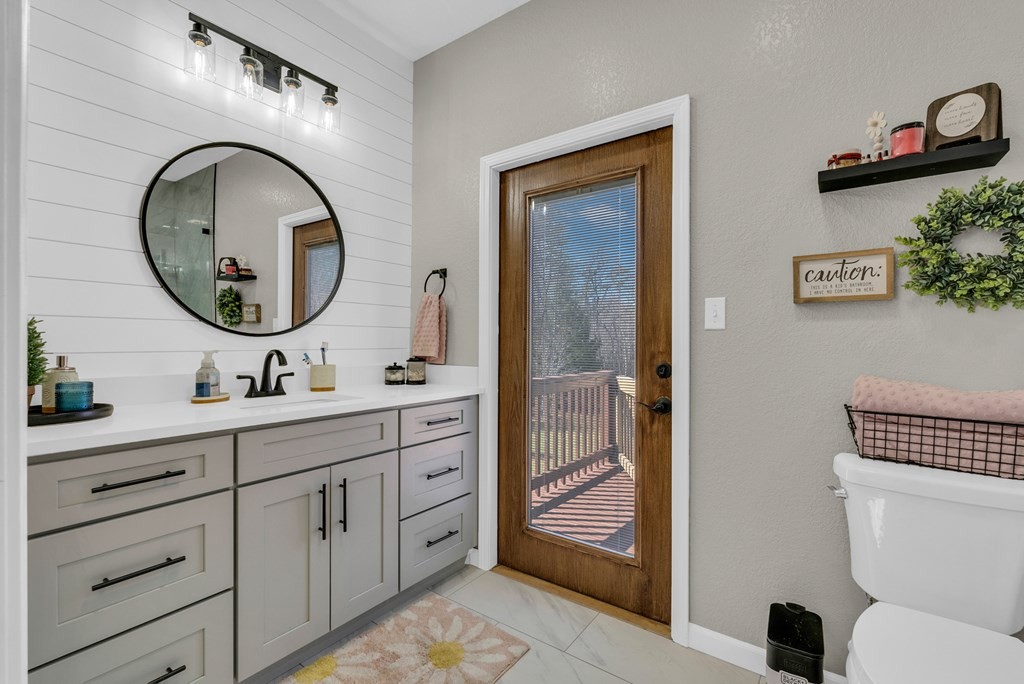 700 Falls Road Monterey, TN 38574 - Photo 28 of 72 a bathroom with a toilet a sink and a mirror