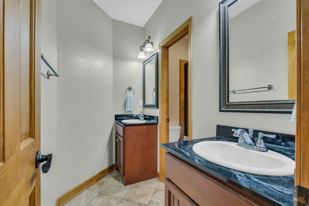 700 Falls Road Monterey, TN 38574 - Photo 38 of 69 a bathroom with a granite countertop sink and a mirror
