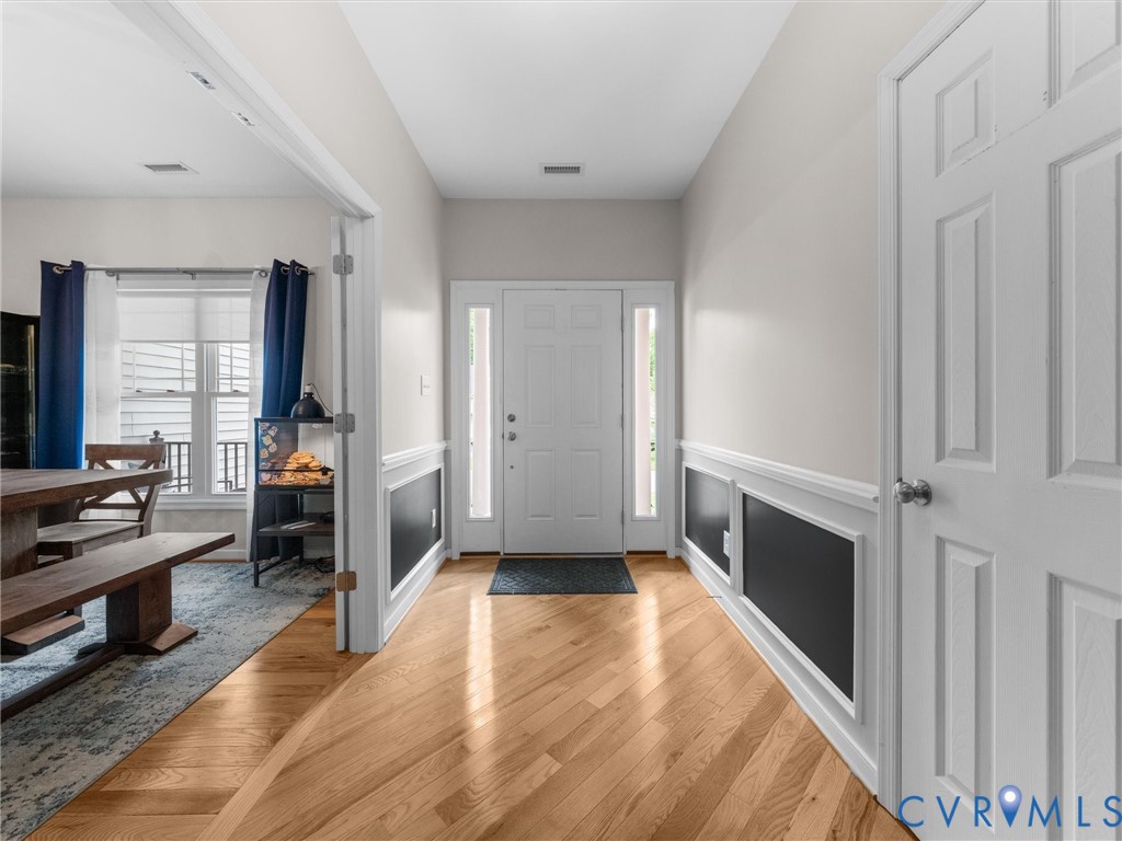 10824 Avening Road Chesterfield, VA 23832 - Photo 6 of 47 a hallway with a wooden floor and a bedroom