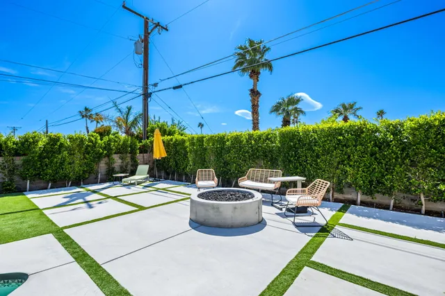 a view of a patio with chairs and table