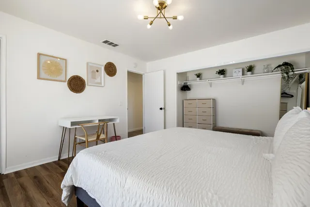 a bathroom with a granite countertop sink toilet a mirror and shower