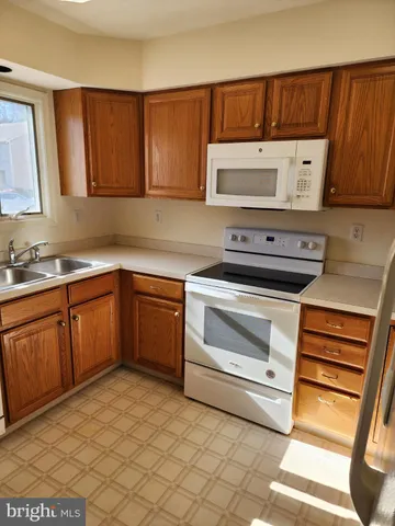 a kitchen with a sink stove and microwave