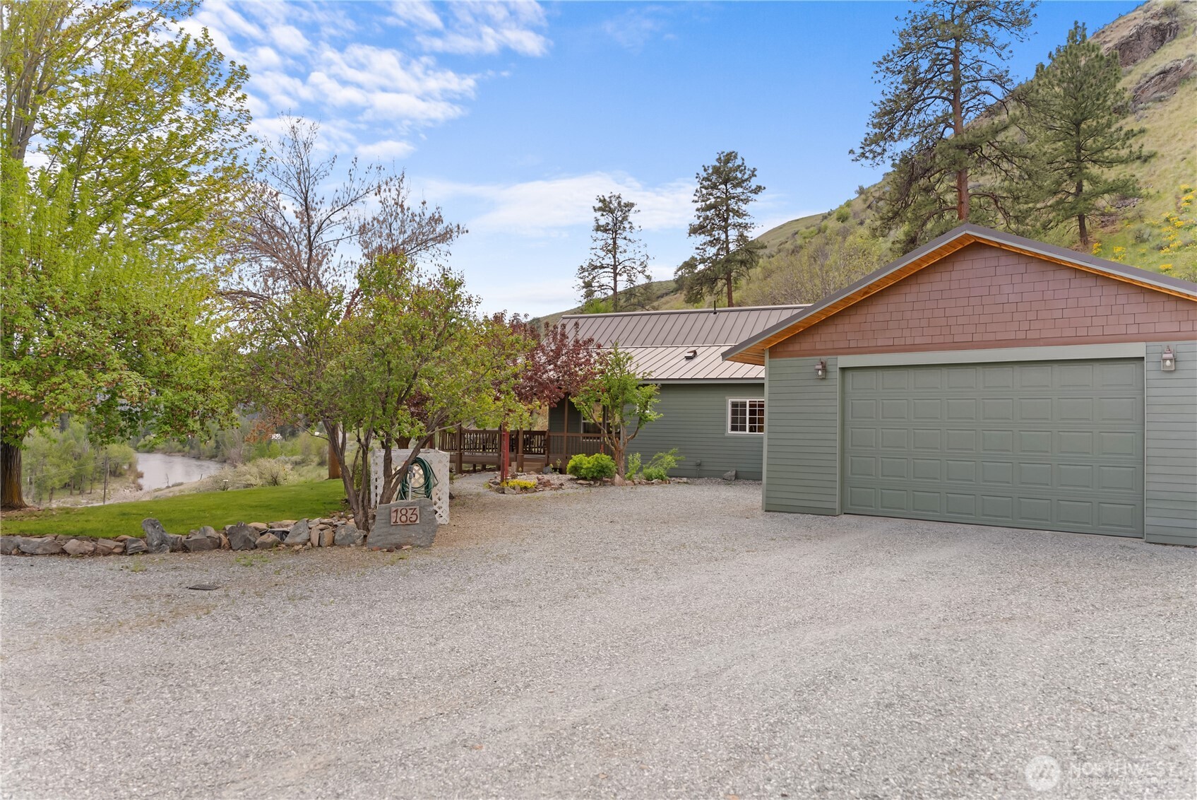 183 Twisp Carlton Road Carlton, WA 98814 - Photo 35 of 40 a view of a house with a yard and garage