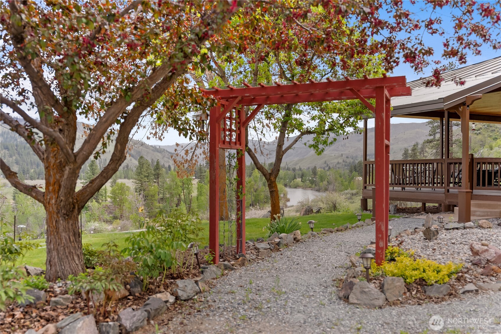183 Twisp Carlton Road Carlton, WA 98814 - Photo 5 of 40 a backyard of a house with large trees and outdoor seating
