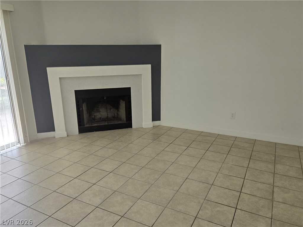 6250 West Flamingo Road, Unit 131 Las Vegas, NV 89103 - Photo 3 of 11 A classic fireplace with a sleek white surround grounds this tiled living space.