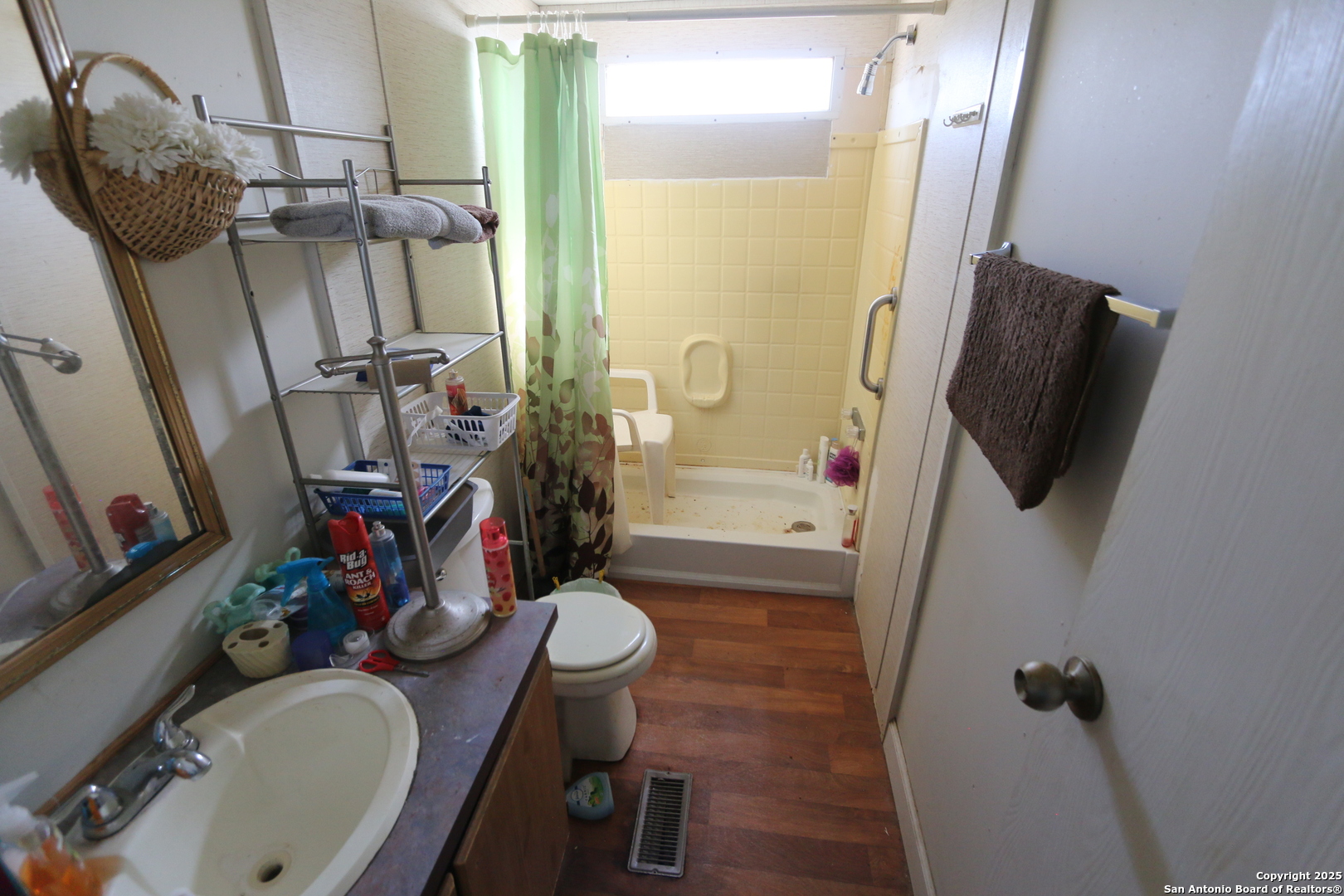 13847 Highway 87 Adkins, TX 78101 - Photo 17 of 23 a bathroom with sink mirror vanity and toilet