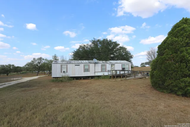 a view of a backyard with wooden fence