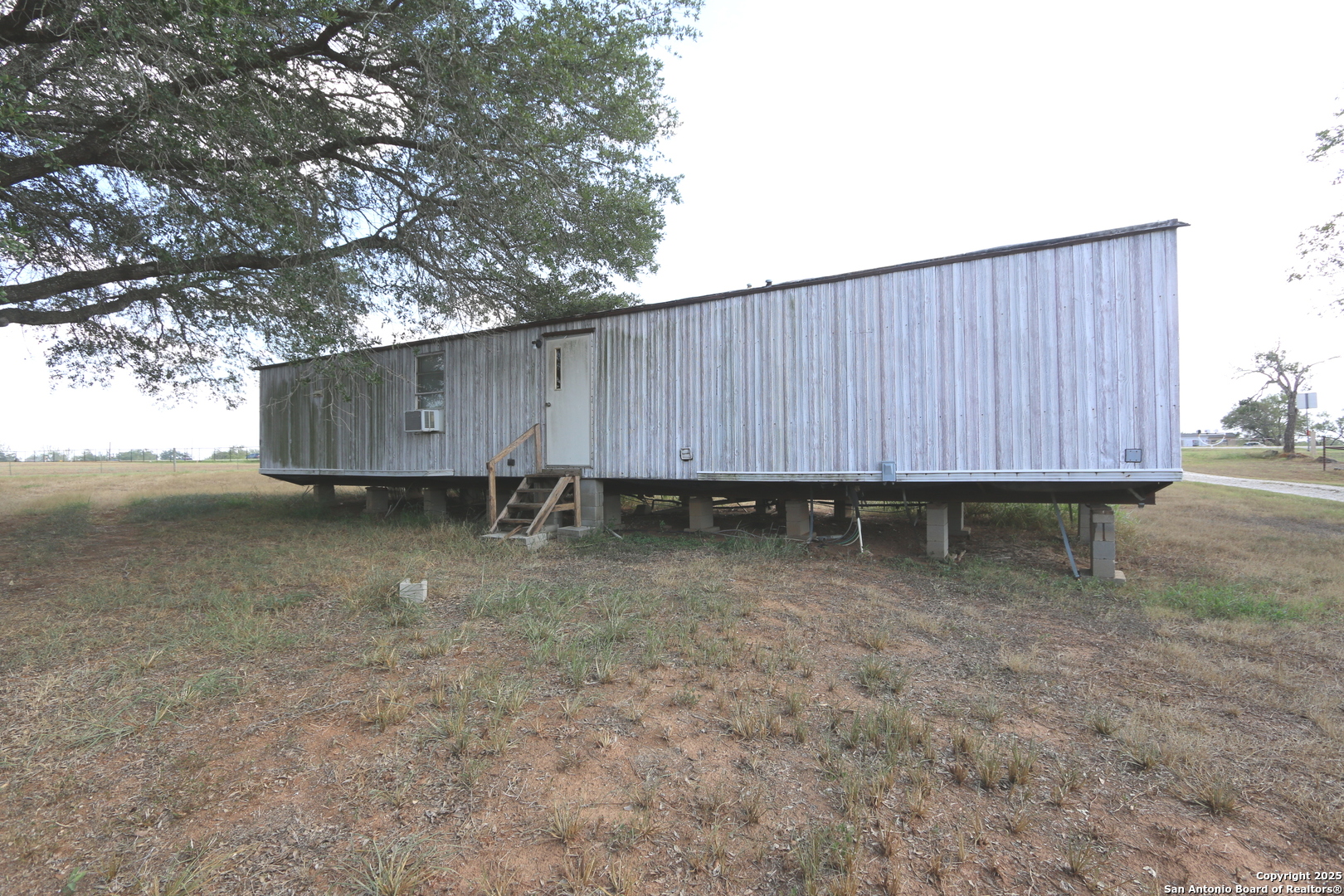 13847 Highway 87 Adkins, TX 78101 - Photo 19 of 23 a view of a backyard with wooden fence