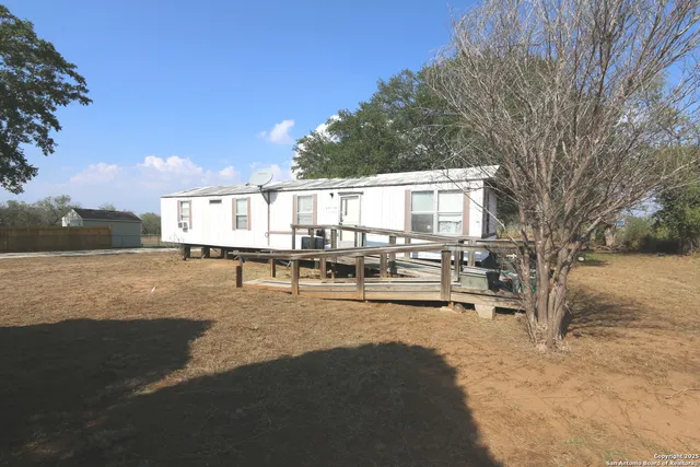 a view of a house with yard and sitting area