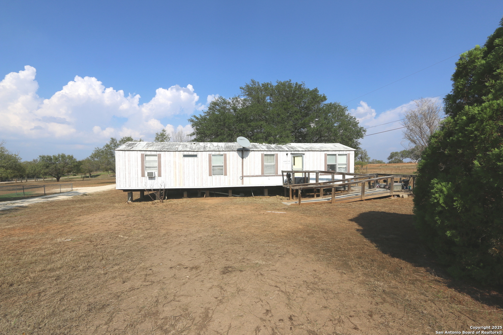 13847 Highway 87 Adkins, TX 78101 - Photo 5 of 23 a view of a house with pool and a yard