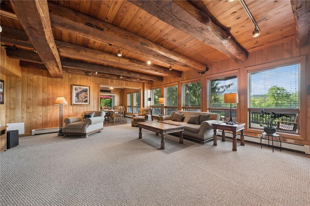 2488 County Line Road Champion, PA 15622 - Photo 7 of 39 Living room with views of North Face Slopes & Cedar beams from the resort, Stone gas fireplace