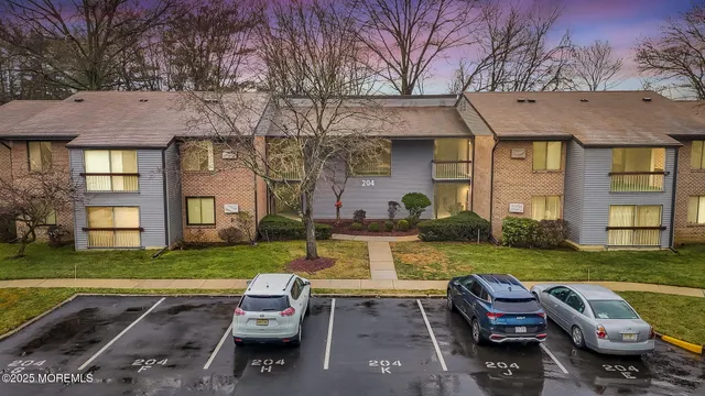 a front view of a house with a garden and swimming pool