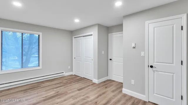a view of a livingroom with wooden floor and closet area