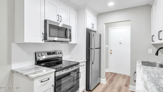 a kitchen with stainless steel appliances a stove a microwave and a refrigerator