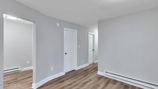 a view of room with window and wooden floor