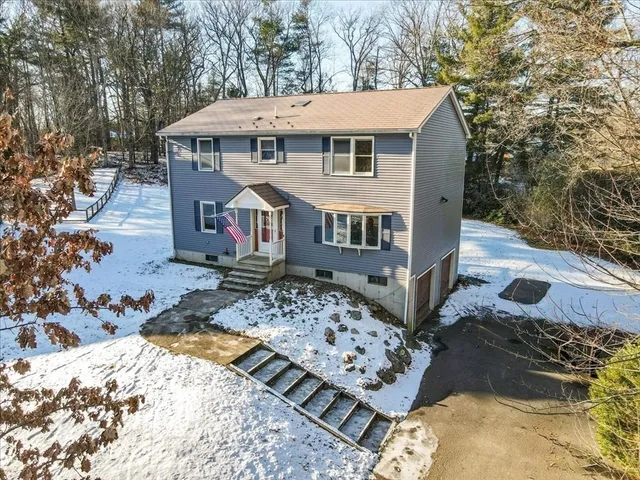 a view of a house with a yard covered with snow in the background