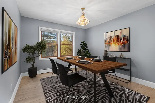 a living room with furniture two window and a flat screen tv