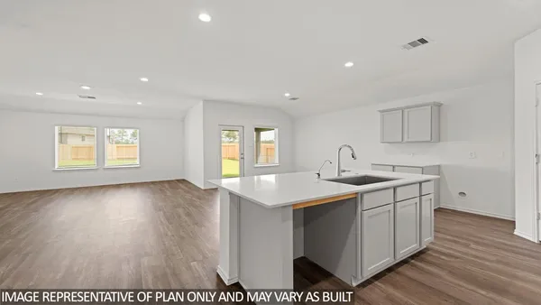 a view of a kitchen counter space a sink and wooden floor