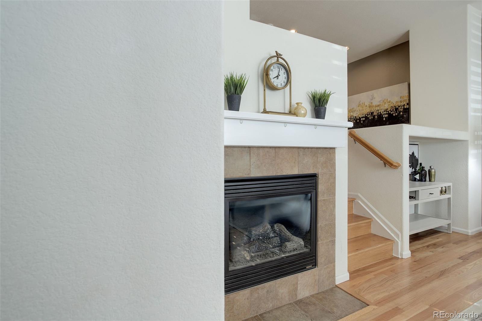 674 Bristle Pine Circle, Unit D Highlands Ranch, CO 80129 - Photo 11 of 31 a living room with furniture and a fireplace