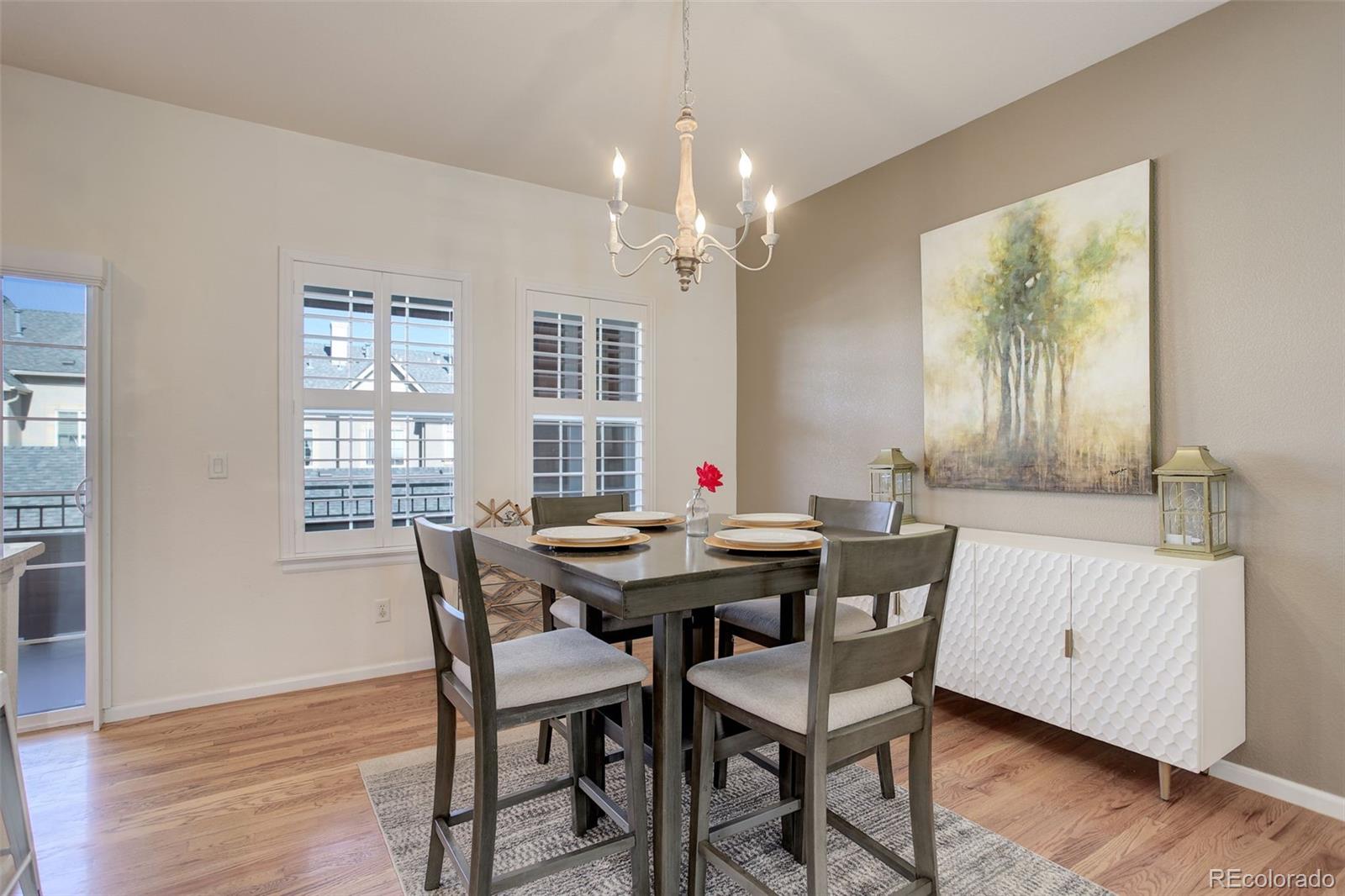 674 Bristle Pine Circle, Unit D Highlands Ranch, CO 80129 - Photo 17 of 31 a view of a dining room with furniture window and wooden floor