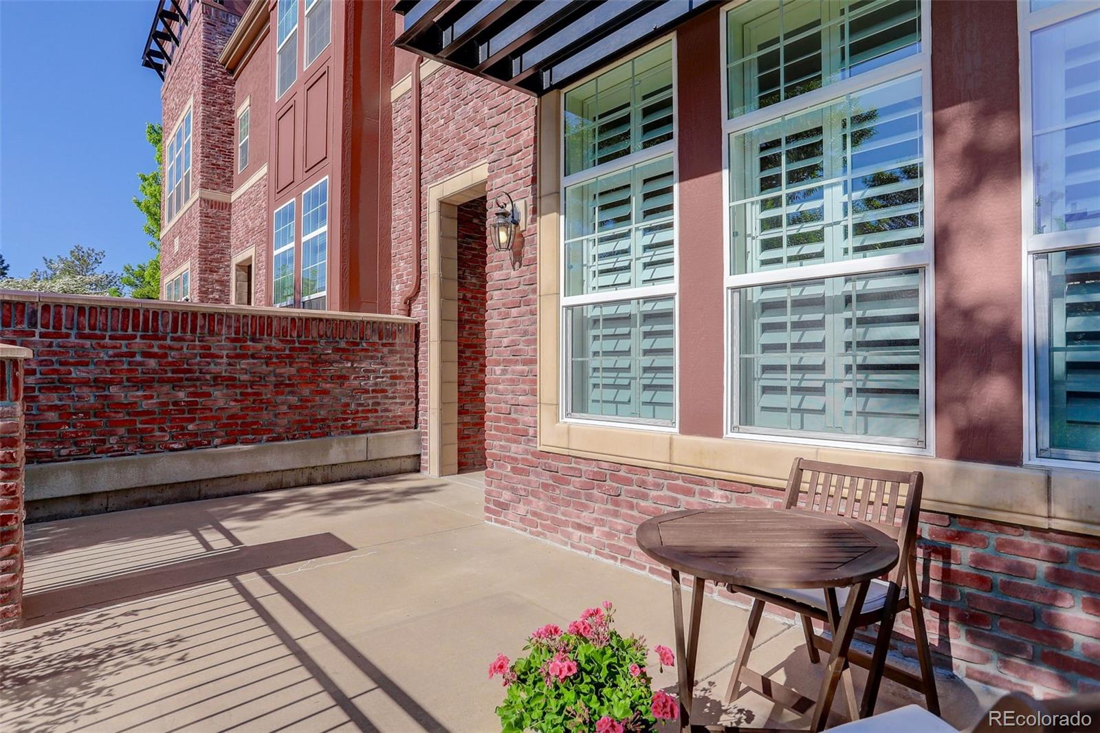 674 Bristle Pine Circle, Unit D Highlands Ranch, CO 80129 - Photo 2 of 31 a view of a chair and table in the backyard of the house