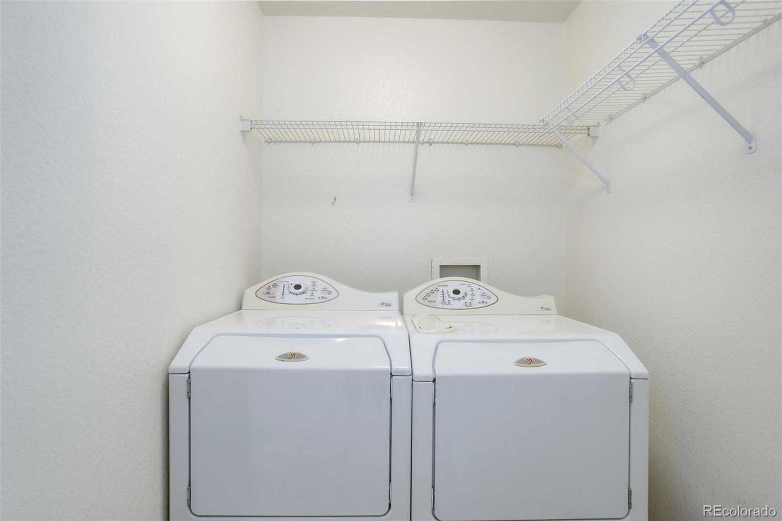 674 Bristle Pine Circle, Unit D Highlands Ranch, CO 80129 - Photo 27 of 31 a utility room with dryer and washer