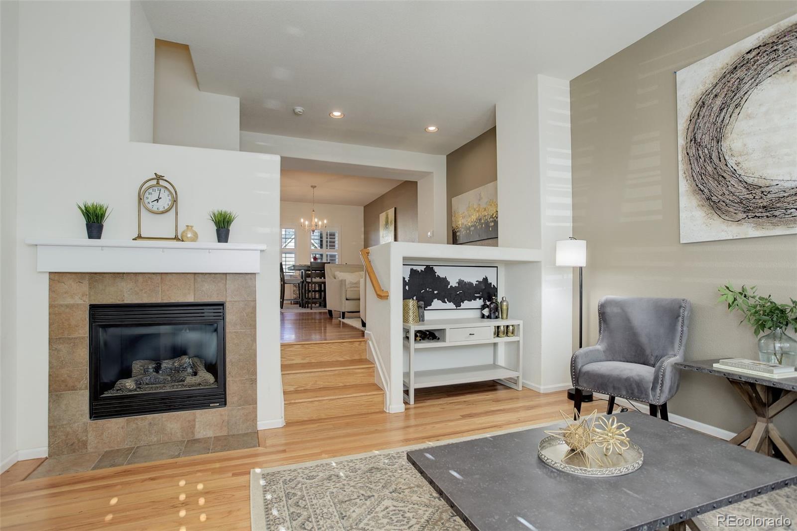 674 Bristle Pine Circle, Unit D Highlands Ranch, CO 80129 - Photo 3 of 31 a living room with furniture and a fireplace