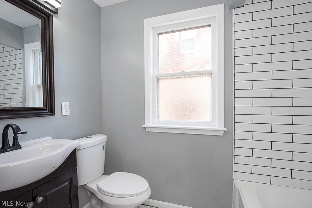 2231 Lorimer Road Cleveland, OH 44134 - Photo 13 of 28 Bathroom featuring a healthy amount of sunlight, toilet, and vanity