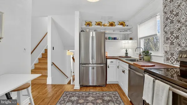 a kitchen with stainless steel appliances granite countertop a refrigerator and a stove