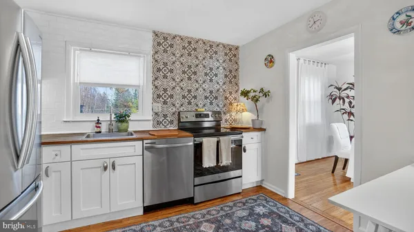 a kitchen with stainless steel appliances granite countertop a stove and a refrigerator
