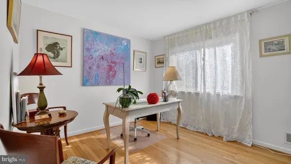 a view of a workspace with furniture and a window