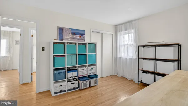 a bedroom with furniture and a wooden floor