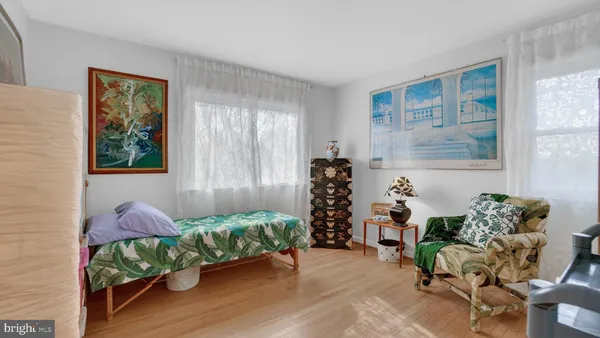 a view of a bedroom with baby crib and toys