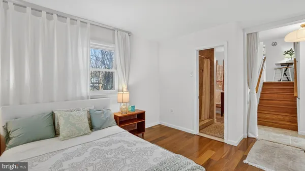 a bathroom with a granite countertop toilet a sink and a mirror