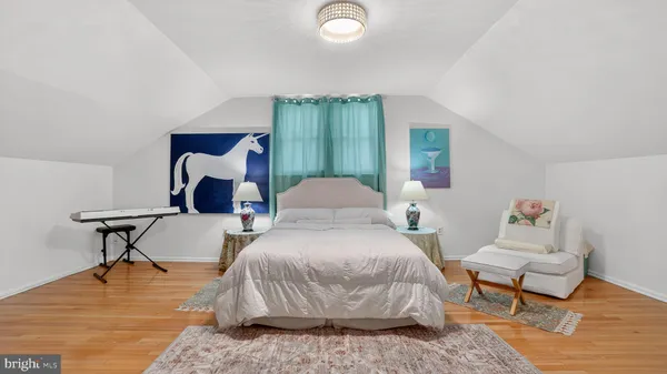 a bedroom with a bed and a couch