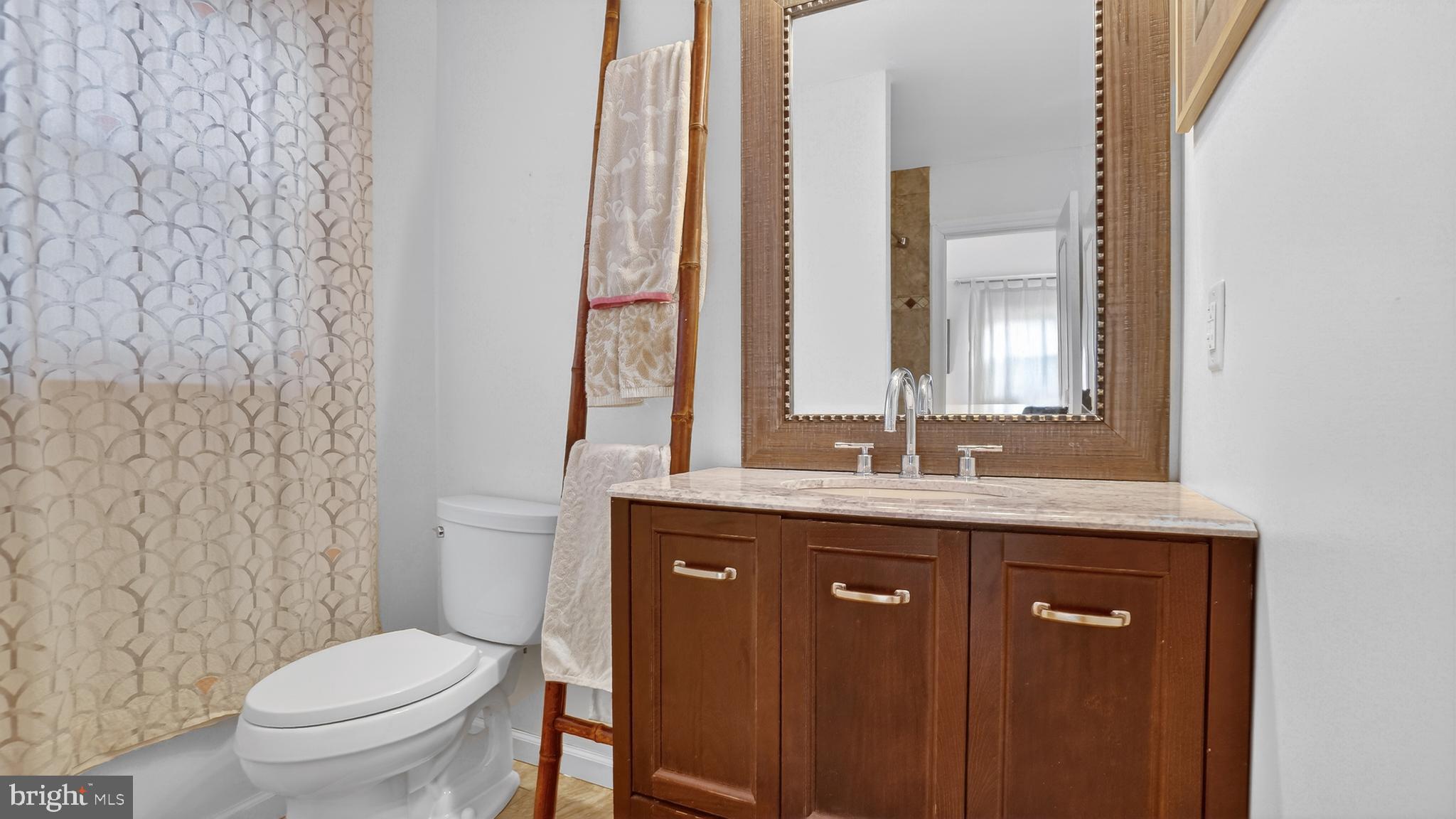 206 Mountain Road Linthicum Heights, MD 21090 - Photo 36 of 53 a bathroom with a granite countertop toilet a sink and a mirror