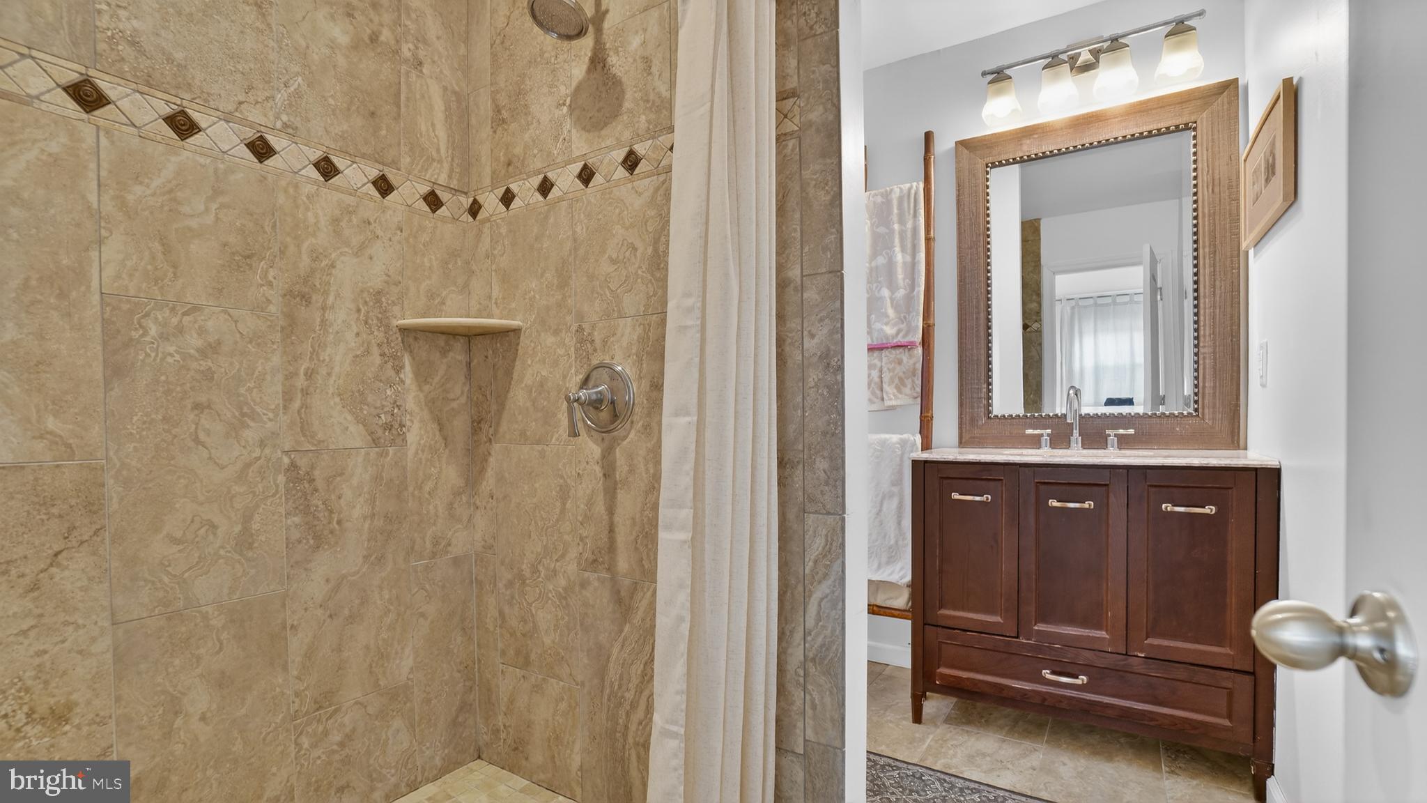 206 Mountain Road Linthicum Heights, MD 21090 - Photo 37 of 53 a bathroom with a sink a mirror and a shower