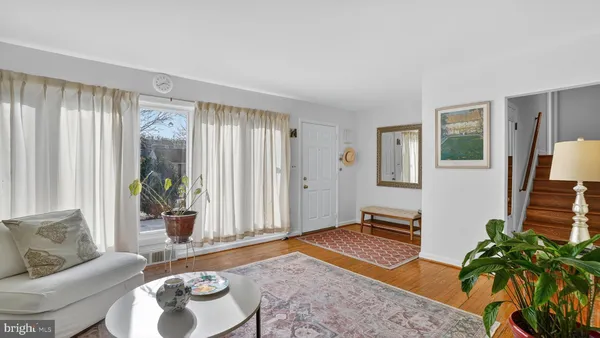 a view of living room filled with furniture and flowers