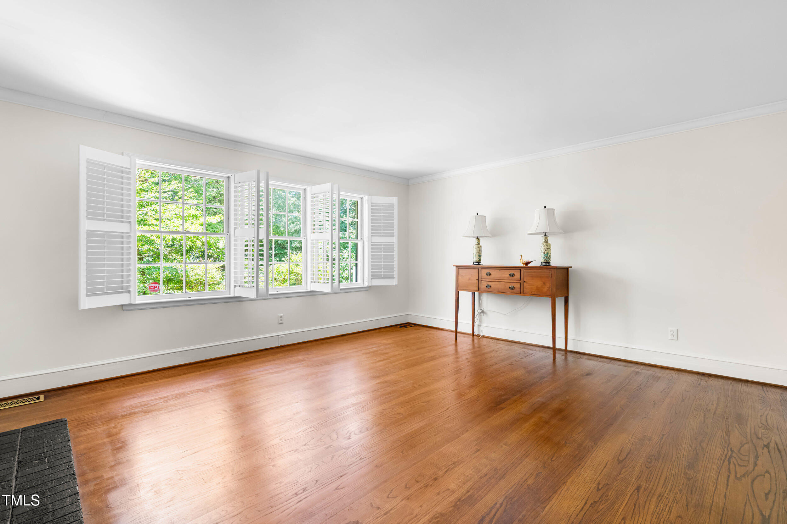2143 Ridge Road Raleigh, NC 27607 - Photo 12 of 40 an empty room with wooden floor and windows