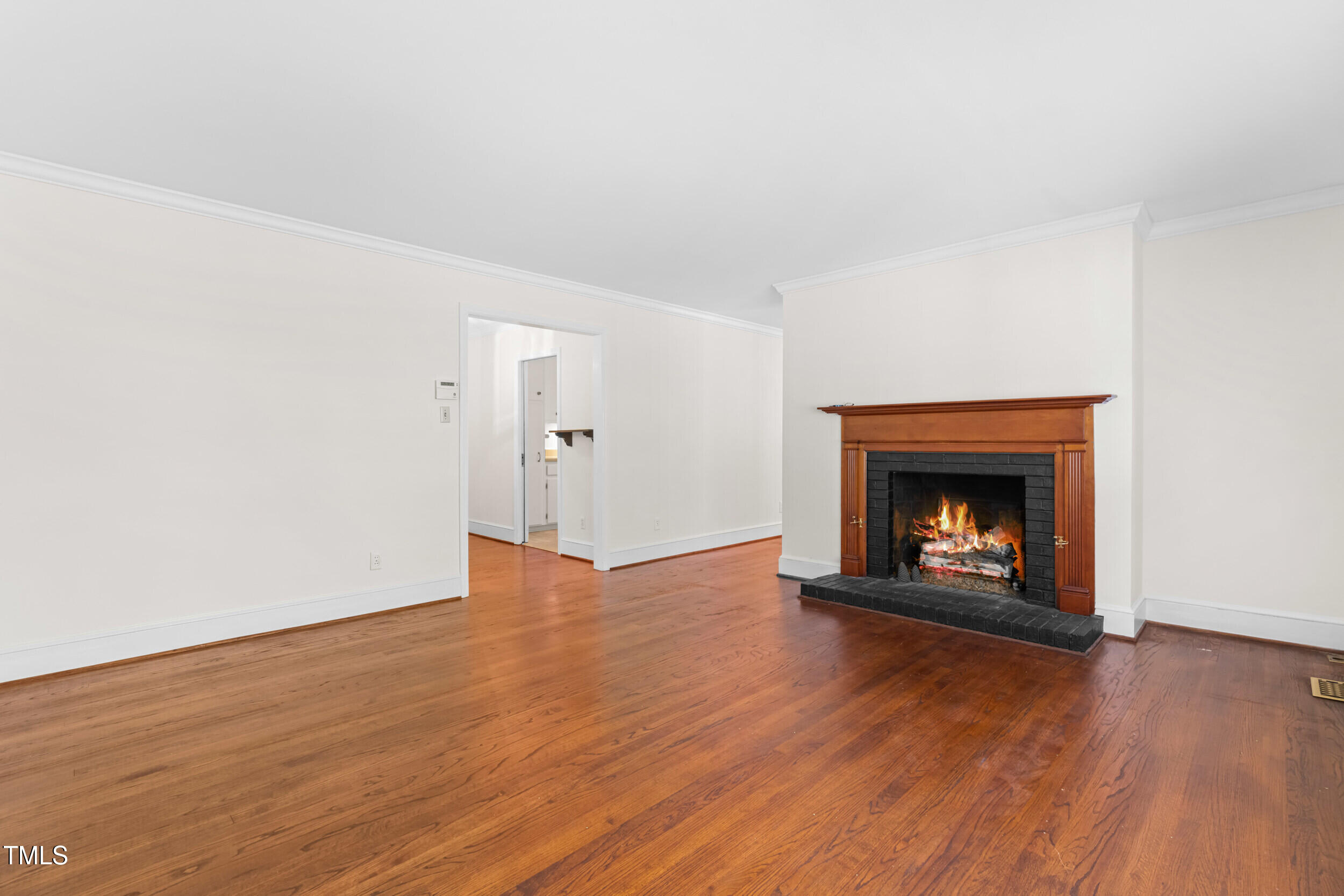 2143 Ridge Road Raleigh, NC 27607 - Photo 13 of 40 an empty room with wooden floor fire place