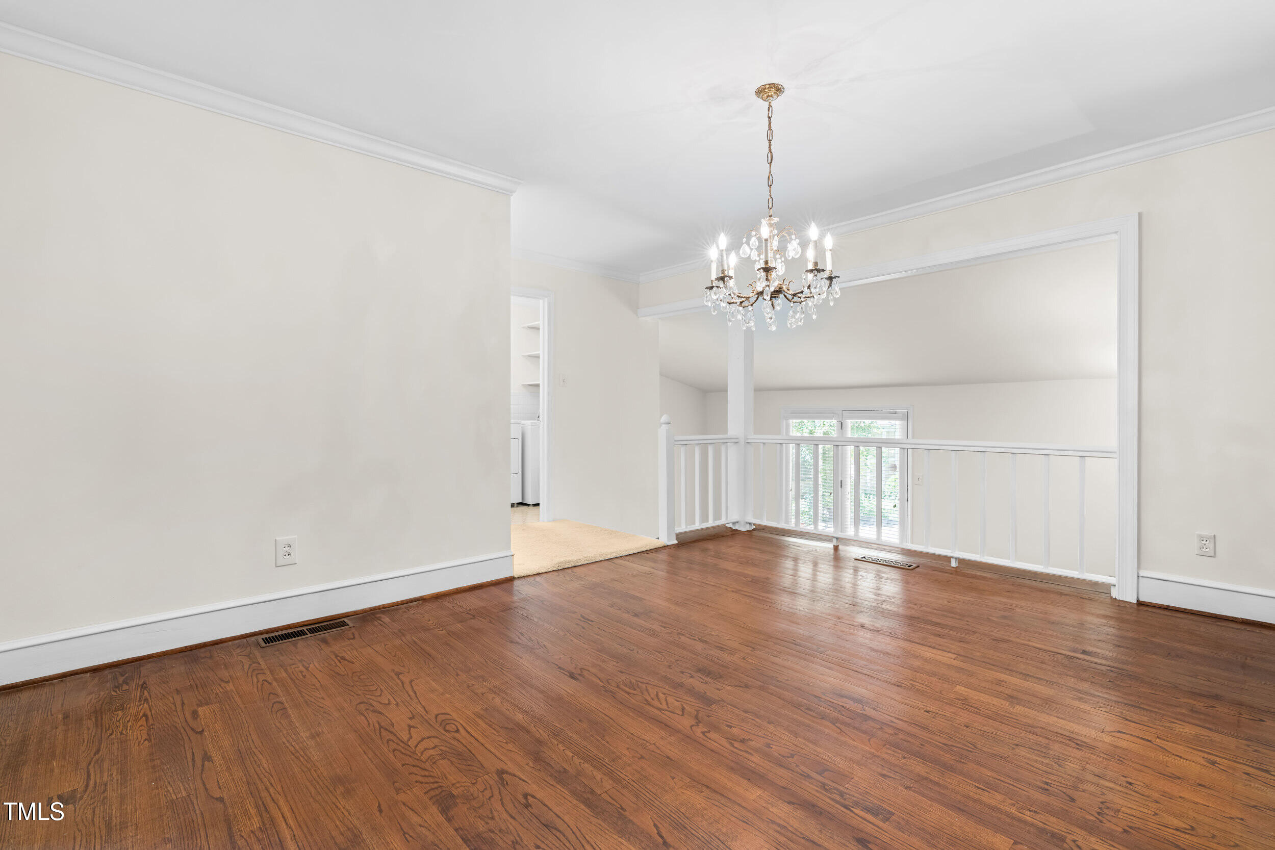 2143 Ridge Road Raleigh, NC 27607 - Photo 14 of 40 a view of a room with wooden floor and chandelier