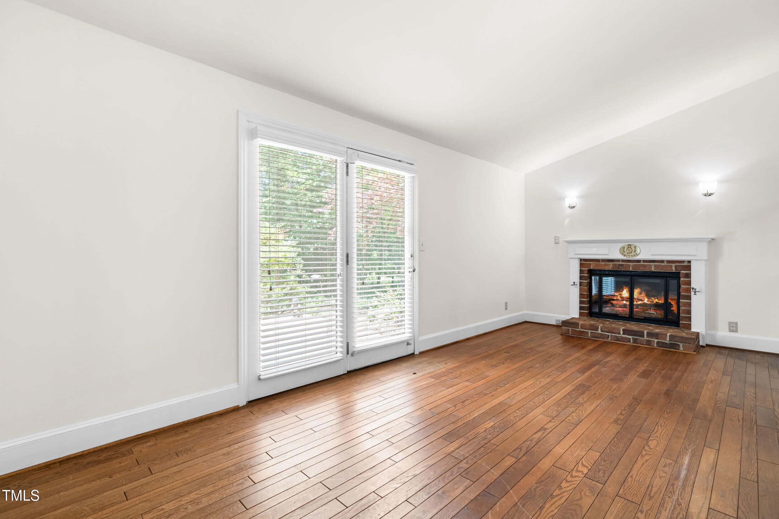 2143 Ridge Road Raleigh, NC 27607 - Photo 18 of 40 a view of an empty room with wooden floor and a window