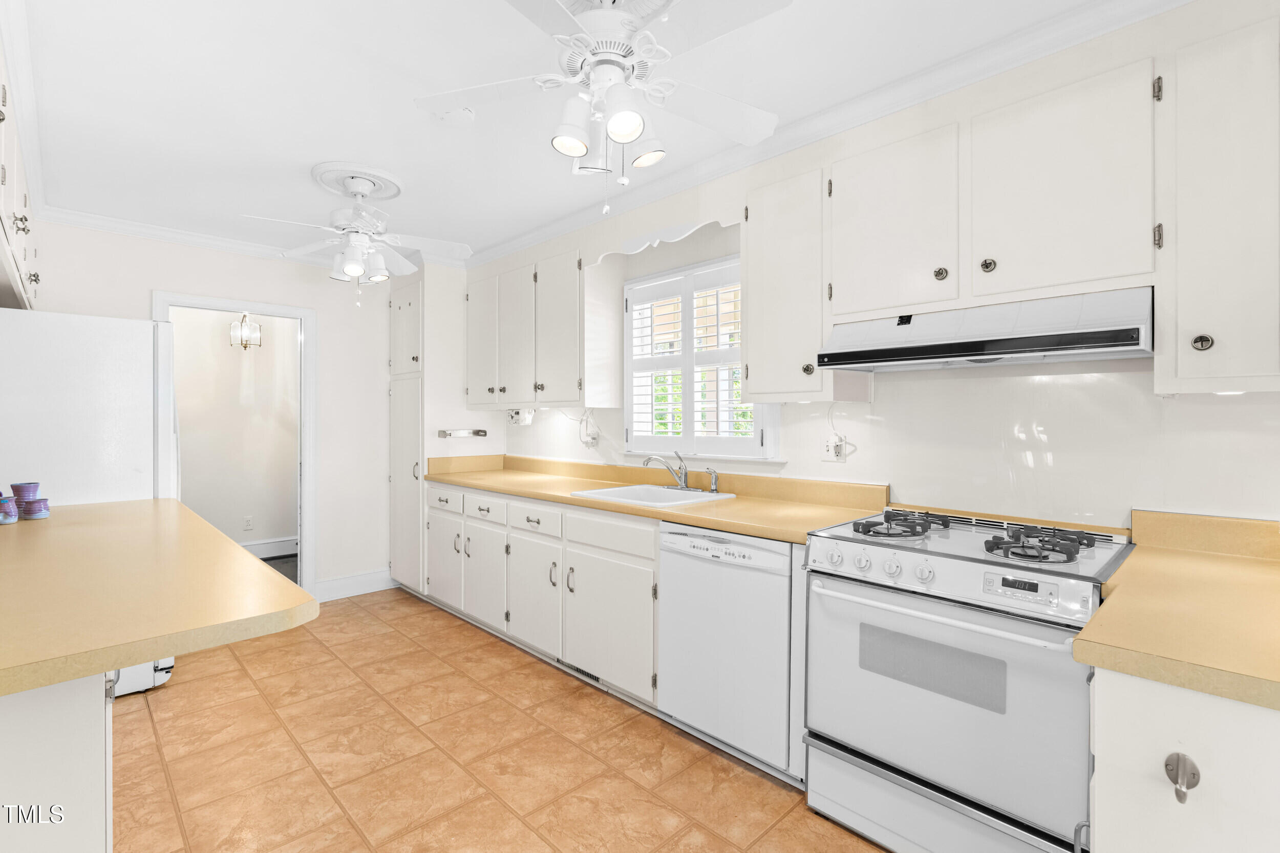 2143 Ridge Road Raleigh, NC 27607 - Photo 20 of 40 a kitchen that has a lot of cabinets in it and wooden floors