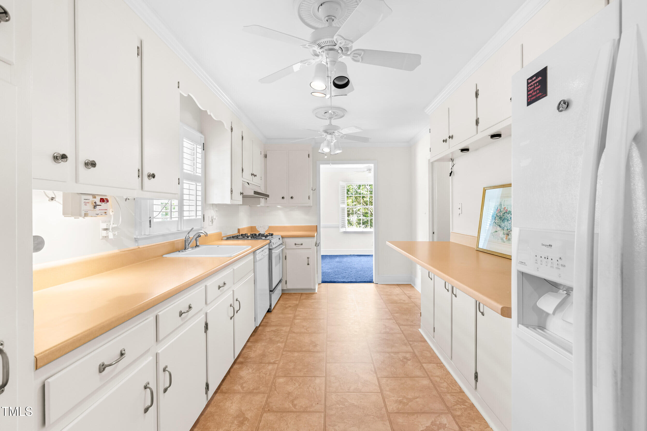 2143 Ridge Road Raleigh, NC 27607 - Photo 21 of 40 a large white kitchen with lots of counter space wooden floor and stainless steel appliances