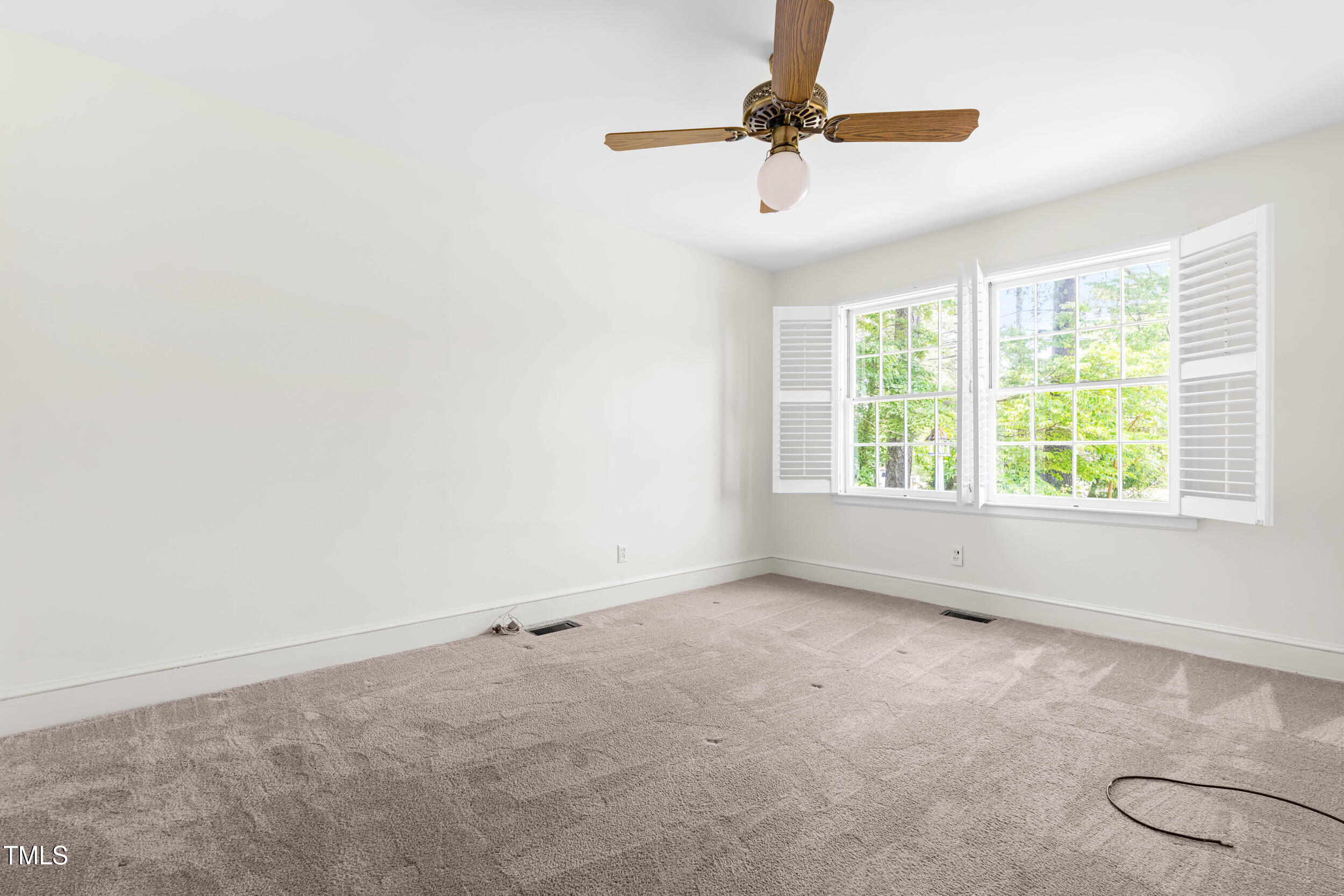 2143 Ridge Road Raleigh, NC 27607 - Photo 27 of 40 an empty room with a window and a fan