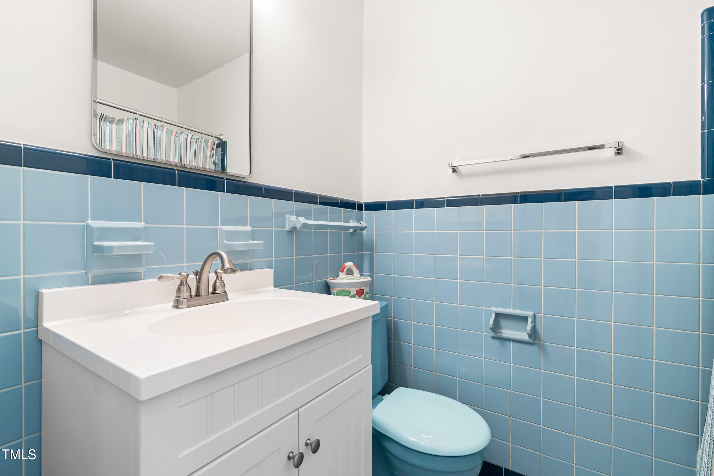 2143 Ridge Road Raleigh, NC 27607 - Photo 30 of 40 a bathroom with a sink a toilet and a mirror